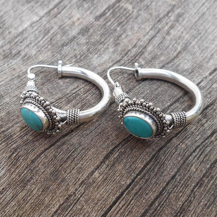 Brincos retrô turquoise da marca Rose & Oliver, design elegante e colorido, detalhes visíveis na imagem.