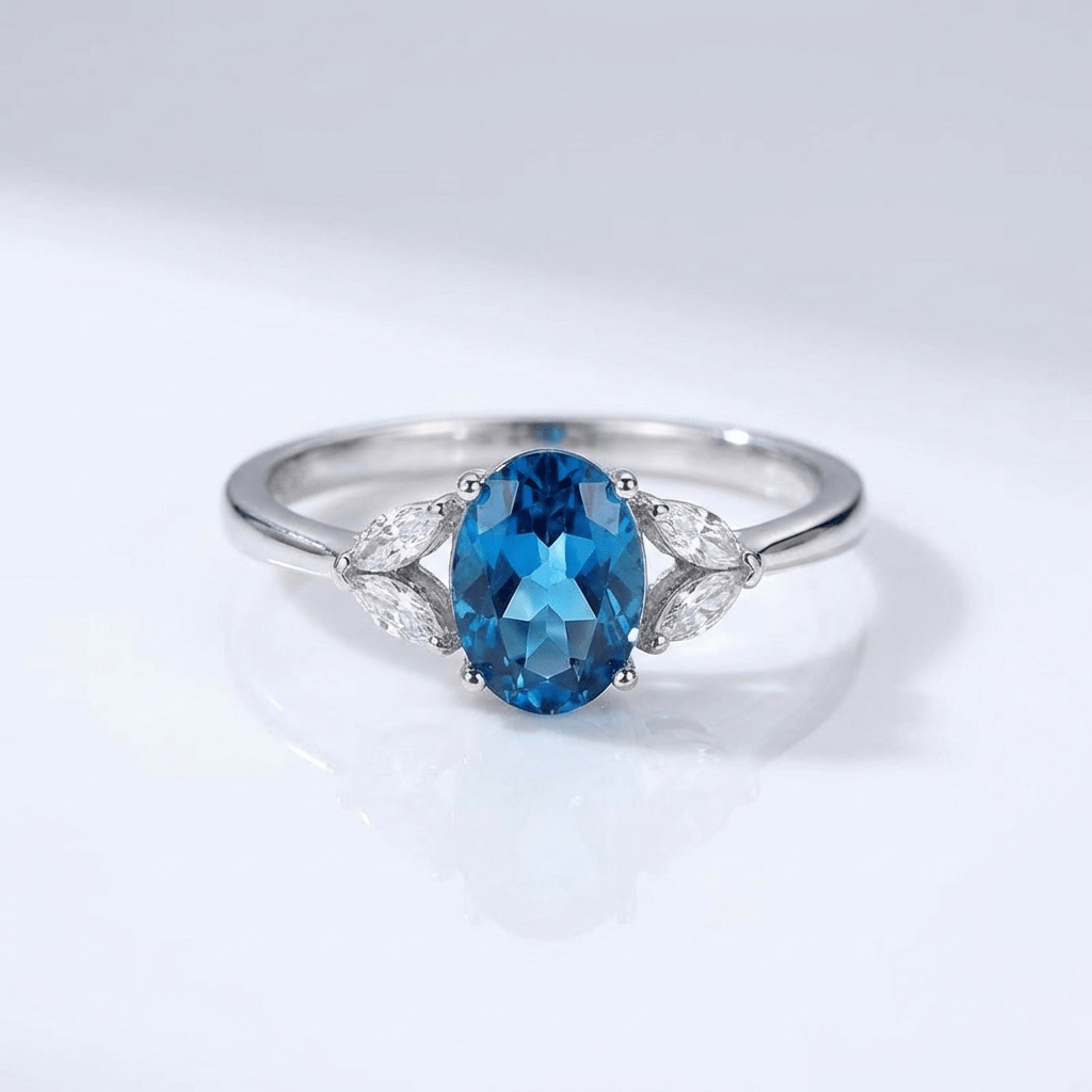 Anel ajustável com topázio oval azul prateado da Rose & Oliver, destaque para a pedra brilhante e a moldura elegante.