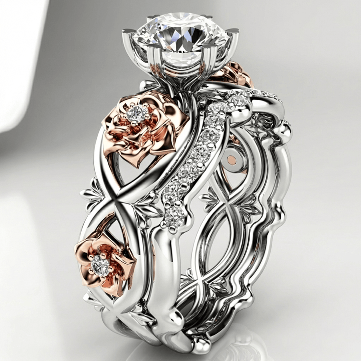 Anel floral em prata rosé com diamantes da Rose & Oliver, delicado e elegante, com detalhes de flores e brilho.