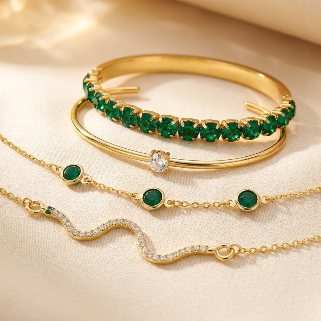 Conjunto de pulseiras de ouro com detalhes em esmeralda da marca Rose & Oliver, mostradas em close-up.